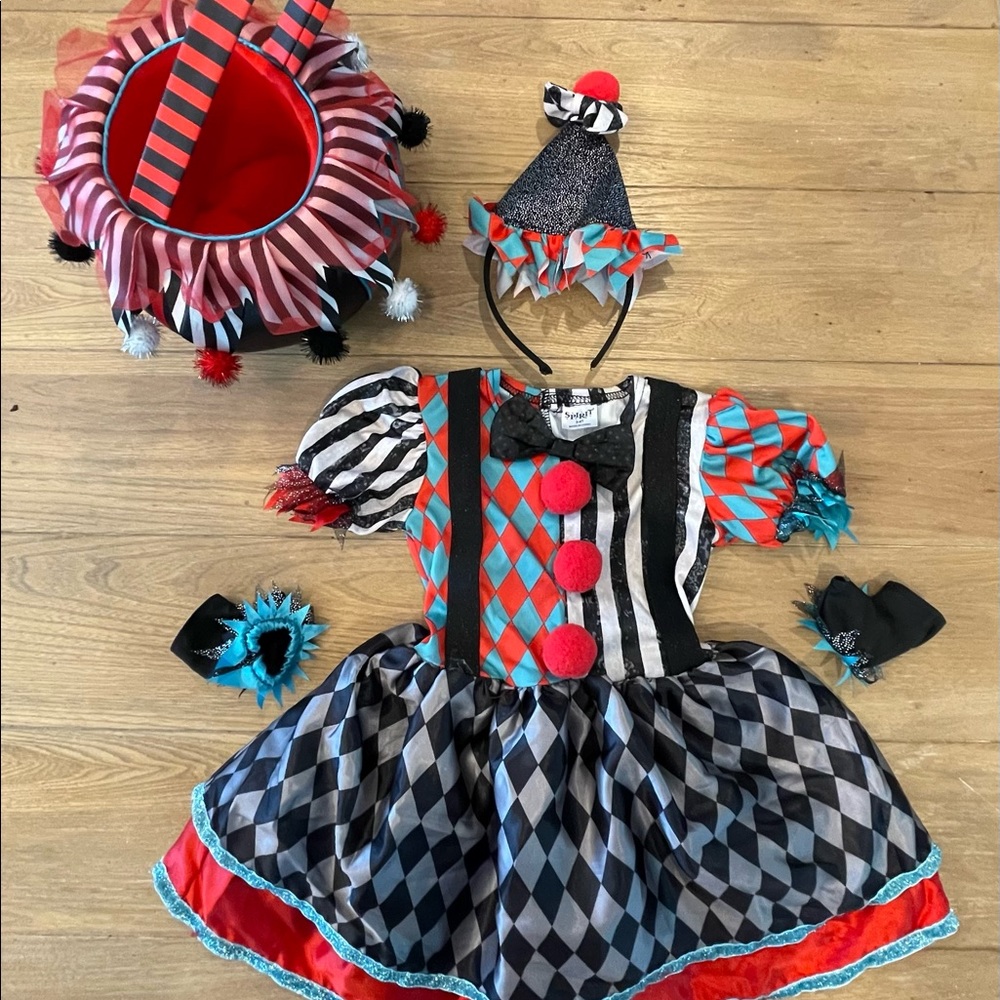 Little girl clown costume and trick or trick matching basket.